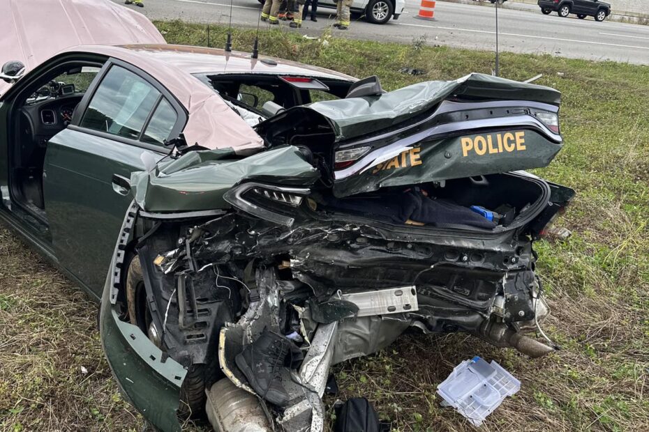 The cruiser, which had its blue lights on, was parked on the shoulder of the highway when the crashed occurred.